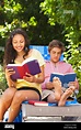 Teenagers reading books outdoors Stock Photo - Alamy