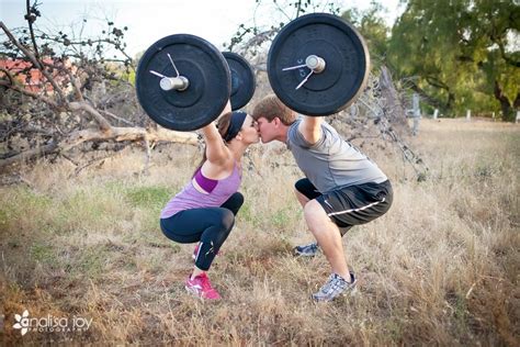 The Man And Woman Are Doing Exercises With Heavy Barbells On Their