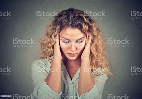 Sad Woman With Stressed Face Expression Looking Down Stock Photo