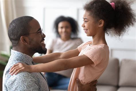 Happy African Father And Kid Daughter Bonding Talking At Home Stock