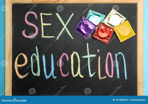 Blackboard With Words Sex Education And Colorful Condoms On Light Blue