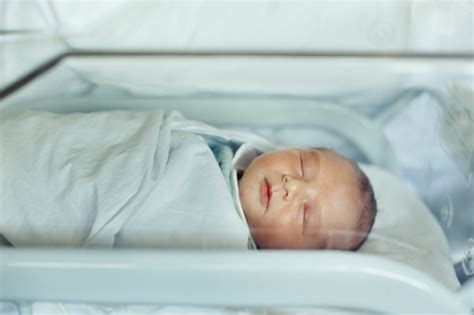 Newborn Baby Boy Asleep In Hospital Bassinet Stock Photo Download