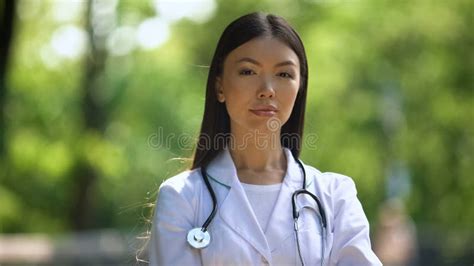 Confident Nurse Looking Into Camera In Hospital Park Medical