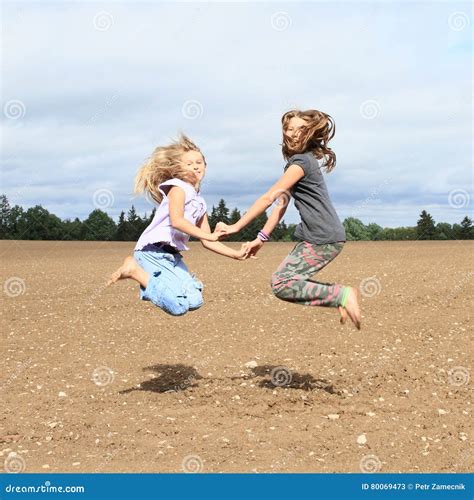 Kids Girls Jumping On Field Stock Image Image Of Hold Cutie 80069473