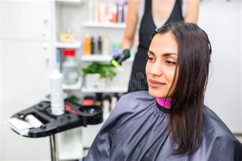 The Hairdresser Applies Professional Liquid Keratin To The Client`s Hair A Girl Does Keratin