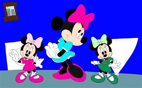 Two Mickey And Minnie Mouses Standing Next To Each Other In Front Of A