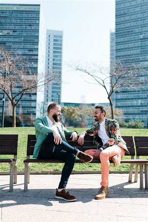 Cheerful Gays On Bench In Business District By Stocksy Contributor Guille Faingold Stocksy
