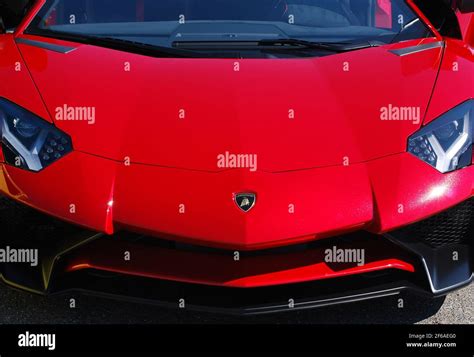 A Red 2012 Lamborghini Aventador Hood Detail With Emblem Stock Photo