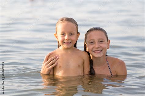 Girls Sisters Have Fun Bathing In The Sea Stock Photo Adobe Stock
