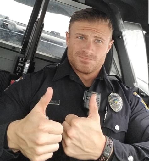 A Police Officer Giving The Thumbs Up Sign