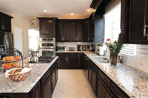 Oak kitchen cabinets with granite countertops. How to Match Your Countertops, Cabinets & Floor