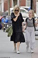 Naomi Watts looks windswept as she walks her son Samuel home from school