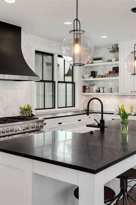 This white kitchen features black soapstone countertop all throughout the kitchen paired with mosaic marble backsplash to add a little pattern and texture to the walls. White Kitchen Cabinets with Black Countertops 2020 ...