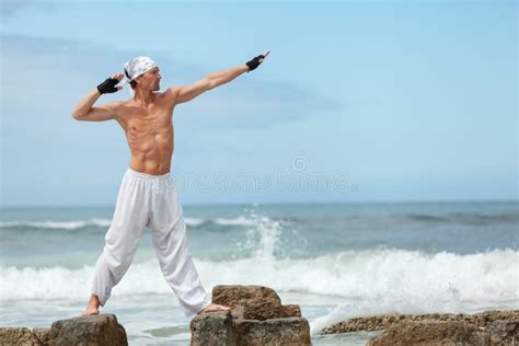 Healthy Man Doing Pilates Yoga Meditation On Beach Summer Stock Image