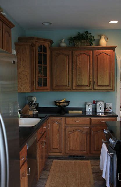 They had honey oak cabinets in their kitchen and honey oak trim throughout the entire home. blue walls plus oak cabinets Not sure if I love this ...