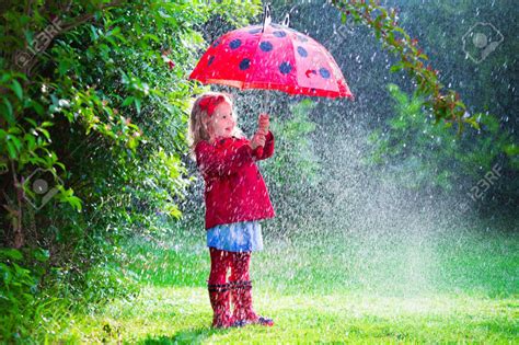 41607821 Little Girl With Red Umbrella Playing In The Rain Kids Play