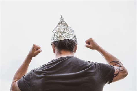 Man With A Tin Foil Hat On His Head Demonstrate Angry Concept