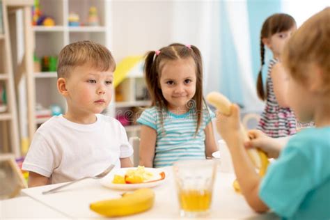 Kids Have A Lunch In Daycare Centre Children Eat Fresh Fruits In