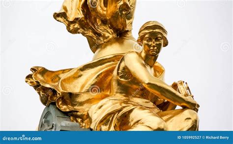 Statue Of Sitting Gold Female Holding Wheel Stock Image Image Of