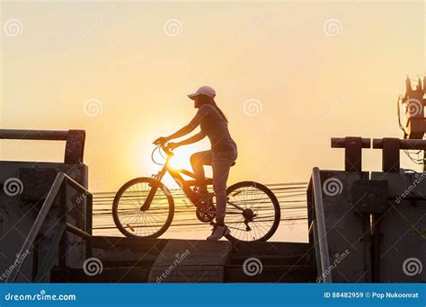 Woman Riding Bicycle Exercising In Sunset Town Stock Image Image Of