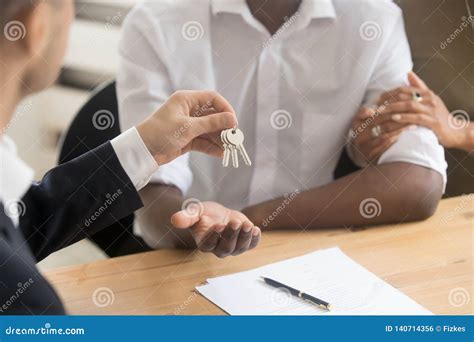 Real Estate Agent Realtor Holding Giving Keys To Black Couple Stock
