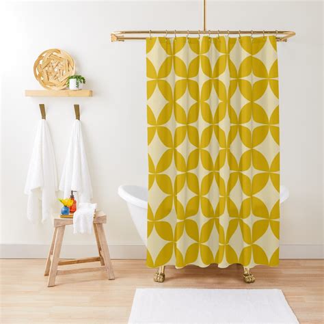 A Bathroom With Yellow Shower Curtain And White Rug