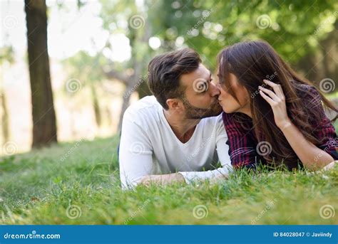 Beautiful Young Couple Laying On Grass In An Urban Park Stock Image Image Of Kiss Smiling