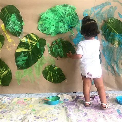 Toddler Art Activities Painting A Leaf Wall Feature Childcare Lean