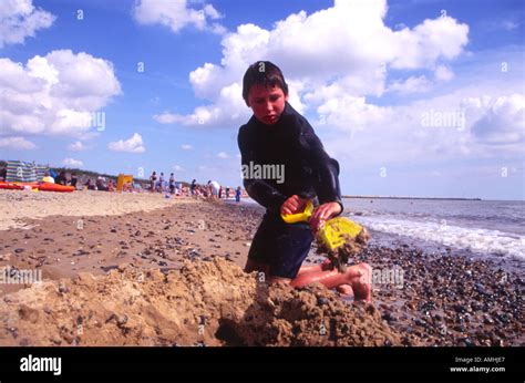 Boy Digging Sand Walberswick Beach Suffolk England Stock Photo Alamy