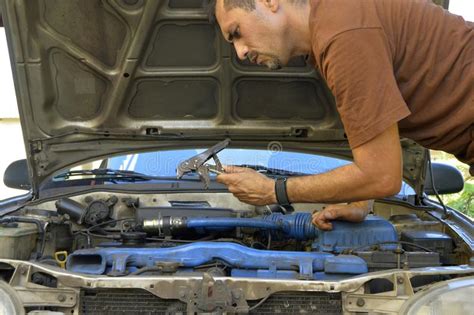 Middle Aged Man Trying To Repair Their Own Cars Stock Image Image Of