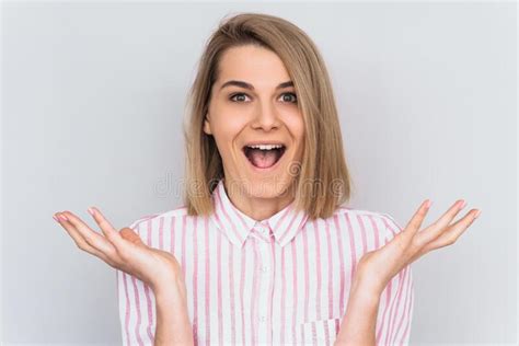 Portrait Of Overjoyed Happy Female Wears Pink Striped Shirt Gestures With Excitement Isolated