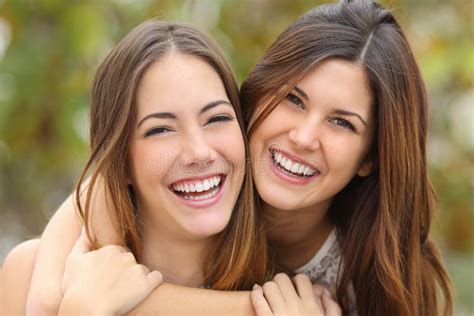 Two Women Friends Laughing With A Perfect White Teeth Stock Photo