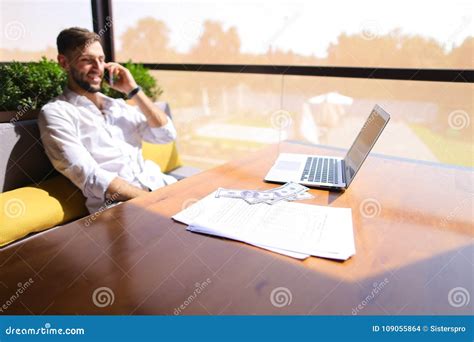 Real Estate Broker Talking By Smartphone And Working With Laptop Stock