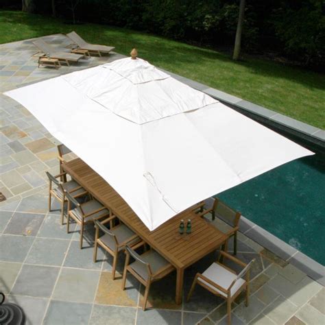 An Outdoor Table And Chairs Under A Large White Awning Next To A