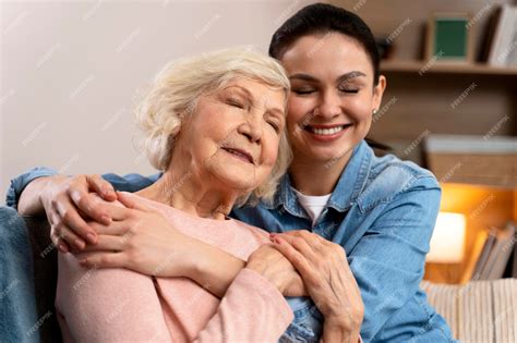 Premium Photo Cheerful Woman Hugging Older Mom With Closed Eyes Happy Senior Mother And Adult