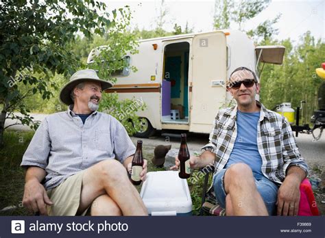 Father And Son Drinking Beer Campsite Outside Camper Stock Photo Alamy