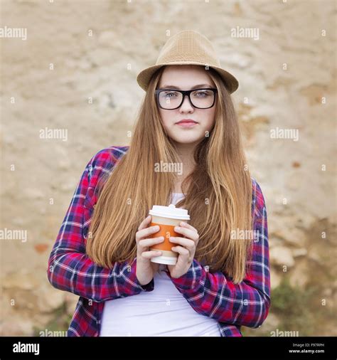 Teenage Hipster Girl Enjoying Her Take Away Coffee In City Street Stock