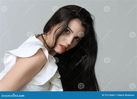 Portrait Of A Woman Who Is Leaning Forward And Showing Curvy Hair Stock