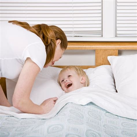Mother Putting Talkative Son To Bed At Bedtime Stock Image Image Of Male Caucasian