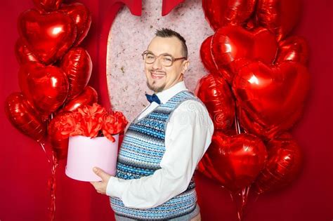 Funny Bearded Retro Style Man Holding Present Box On The Red Heart Shape Balloons For Valentine