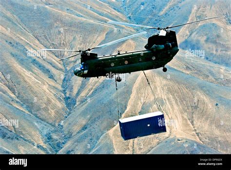 Us Army Ch 47 Chinook Helicopter Carries A Sling Loaded Shipping