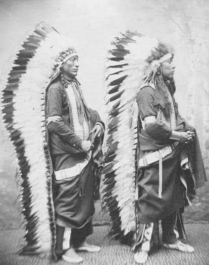 two native american men standing next to each other