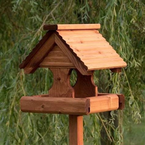 Normal bird feeders have a lot of problems. Rustic Bird Table with Perches and a Decorative Timber Roof