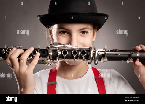 Little Girl Playing Clarinet On A Gray Background Stock Photo Alamy