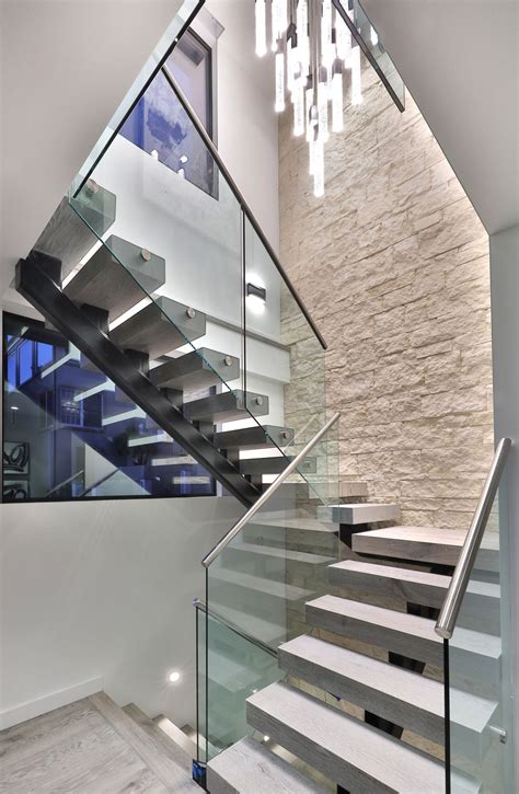 Steel Beam Staircase With Chandelier And Stone Wall Staircase Wall