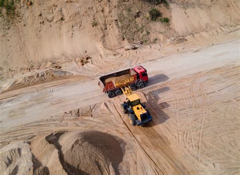 Wheel Loader Loading Sand Into Dump Truck At The Open Pit Mine Mining