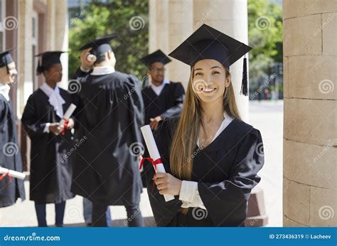 Portrait Of Attractive Happy Graduate Student In Mortar Board Cap And