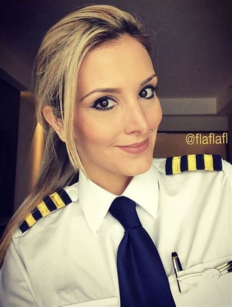 a woman in uniform is smiling for the camera while wearing a navy tie and pilot s shirt