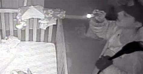 burglar stares at sleeping infant caught on tape cbs news