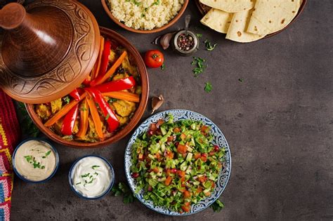 Premium Photo Traditional Tajine Dishes Couscous And Fresh Salad On